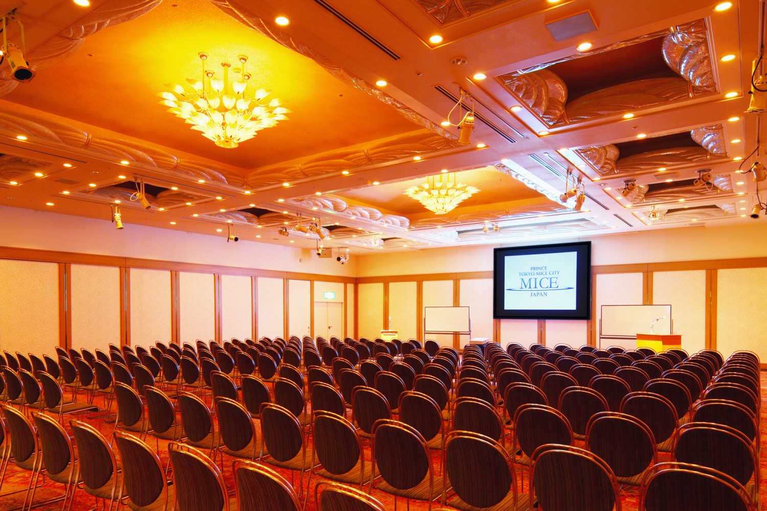 Hotel conference hall set up with rows of chairs